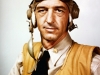 Lieutenant Commander John S. "Jimmy" Thach wears a "Mae West" life vest, helmet and goggles. In the first decades of Naval Aviation history, aviators regularly wore ties when flying.