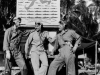 Members of Marine Torpedo Bombing Squadron (VMTB) 232  wear flight gear typical of that worn by Naval Aviators during World War II.  Note the scoreboard touting the squadron's combat record.