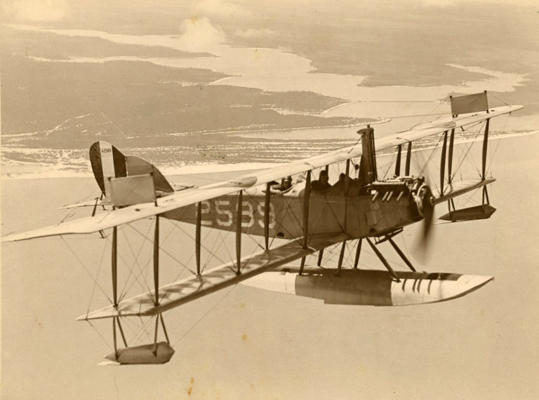 An N-9 pictured during a training flight near NAS Pensacola. Note the tower radiator visible forward of the upper wing. Arriving at NAS Pensacola in December 1918, this particular airplane was damaged on three occasions and repaired before it spun into the water in 1921.