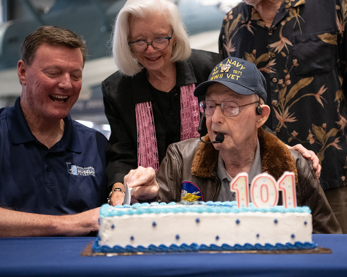 Cash Barber cutting into his 101st blue and white birthday cake.